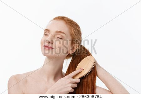 Beautiful Women Combing Hair With Wooden Comb Isolate Over White Background.