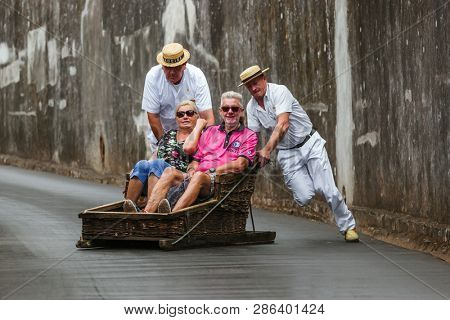FUNCHAL, MADEIRA - SEPTEMBER 19: Traditional downhill sledge trip on September 19, 2016 in Madeira, Portugal.