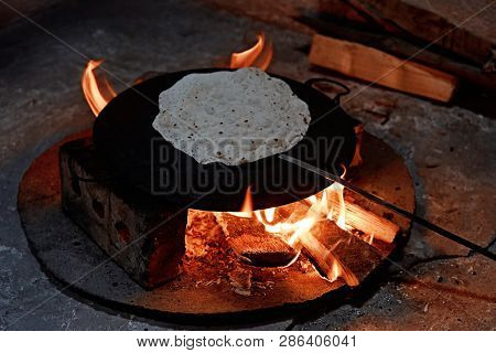 Pita Bread Baking On A Saj Or Tava On  Fire, Close-up.