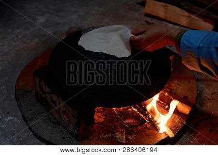 Pita Bread Baking On A Saj Or Tava On Fire, Close-up
