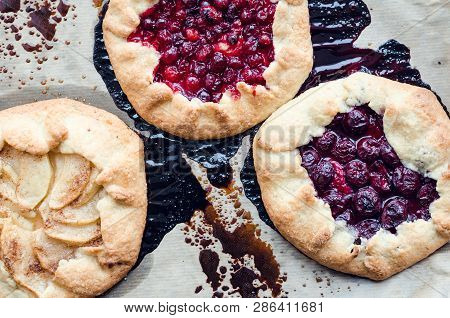 Homemade Fruit And Berries Galette On Backing Tray. Process Of Baking. Open Pie, Apple, Cranberries 