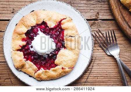 Homemade Cranberries Galette On Wooden Table. Open Pie, Cranberries Tart. Berry Bakery. Summer Food,