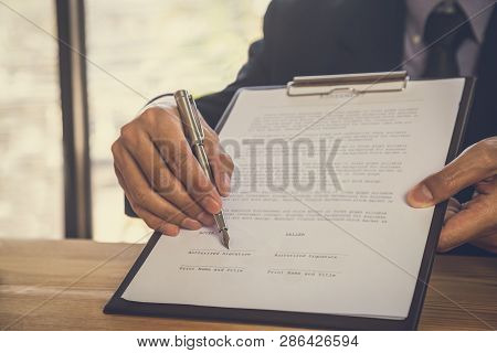 Business Man Signing A Contract. Owns The Business Sign Personally, Director Of The Company, Solicit