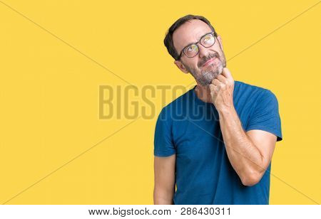 Handsome middle age hoary senior man wearin glasses over isolated background with hand on chin thinking about question, pensive expression. Smiling with thoughtful face. Doubt concept.