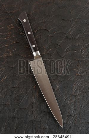 Never used kitchen knife on dark oak wood