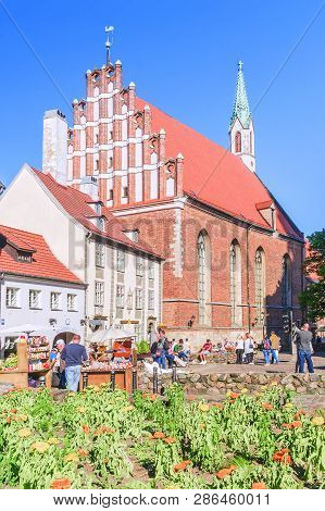 Riga, Latvia - June 12, 2017: Old City Streets. The Church Of St. John Is A Lutheran Church In Riga