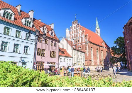 Riga, Latvia - June 12, 2017: Old City Streets. The Church Of St. John Is A Lutheran Church In Riga