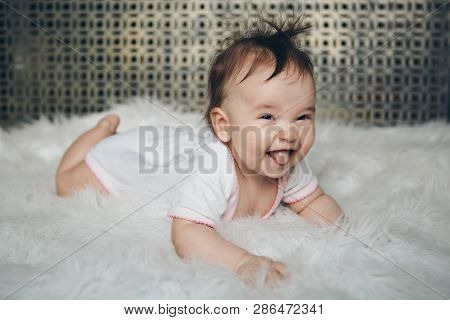 Portrait Of A Newborn Baby With His Tongue Sticking Out