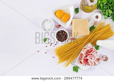 Ingredients For Cooking Carbonara Pasta, Spaghetti With Pancetta, Egg, Peppers, Salt And Hard Parmes