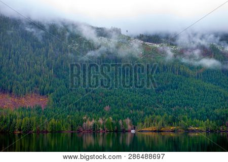 Morning fog in the mountains around Sproat lake in Vancouver Island, British Columbia, Canada