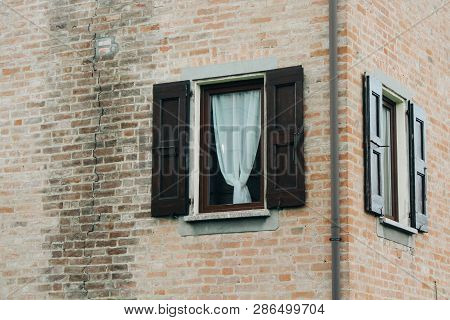 Maranello, Italy - 03 26 2013: View Of The Streets Of Maranello. Windows With Blindes On The House