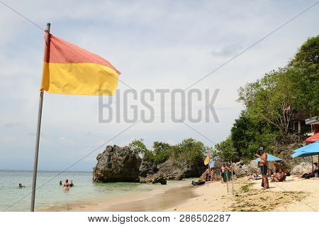 Bali, Indonesia- 14 Feb, 2019: Flag Showing Edge Of Lifeguard Safety Zone On Beach At Padang Padang 
