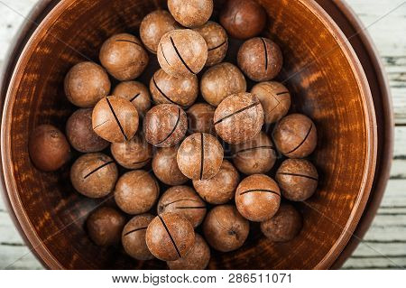 Macedonian Nuts On A Wooden Plate On The Background Of A Textural Wooden Table. Macedonian Nuts Clos