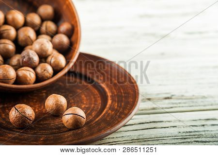 Macedonian Nuts On A Wooden Plate On The Background Of A Textural Wooden Table. Macedonian Nuts Clos