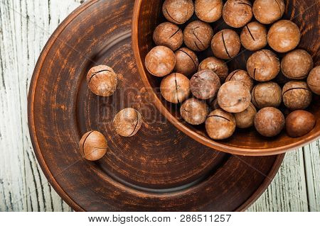 Macedonian Nuts On A Wooden Plate On The Background Of A Textural Wooden Table. Macedonian Nuts Clos