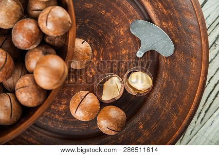 Macedonian Nuts On A Wooden Plate On The Background Of A Textural Wooden Table. Macedonian Nuts Clos