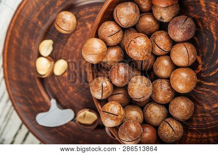 Macedonian Nuts On A Wooden Plate On The Background Of A Textural Wooden Table. Macedonian Nuts Clos