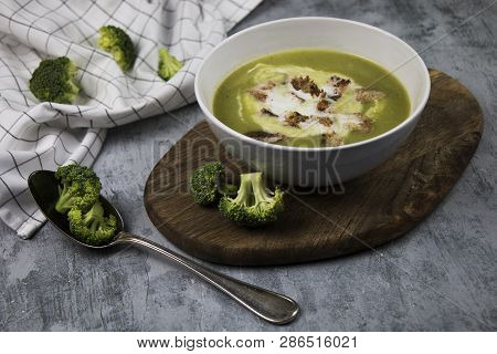 Photo Of Served Brocoli Creamy Soup With Cream And Bread Croutons On Rustic Table With Spoon And Fre
