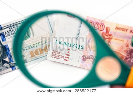 Five Thousand Russian Rubles  Under A Magnifying Glass On The Bacdrop Euro And Usa Dollar. Сoncept O