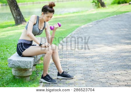 Beautiful Sport Fitness Girl In Sportswear Doing Fitness Exercise Sitting And Lifting Weigth With Du