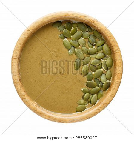 Natural Paste From Pumpkin Seeds In Wooden Bowl Isolated On White. Pumpkin Urbech, Pumpkin Seed Butt