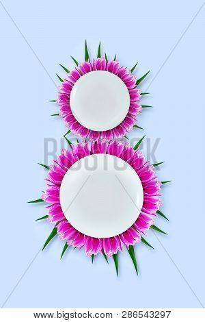 March 8 Made Up Of Plates With Tulips On A Blue Background. Copy Space. Happy Women's Day Background