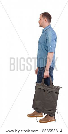 Back view of a man with a green bag.  backside view of person.  Rear view people collection. Isolated over white background. The guy in the shirt with the bag looks sideways.