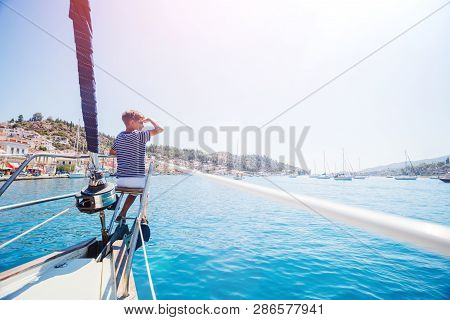 Little Boy On Board Of Sailing Yacht On Summer Cruise. Travel Adventure, Yachting With Child On Fami