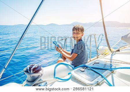 Little Boy On Board Of Sailing Yacht On Summer Cruise. Travel Adventure, Yachting With Child On Fami