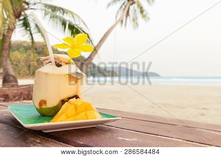 Coconut On Mango Background. Tropical Fruits. Summer Concept. Drink. Summer Concept