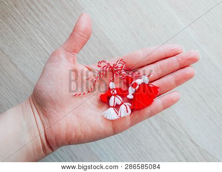 Bulgarian Traditional Spring Decor Martenitsa, Holding In Hand, Wooden Background. Baba Marta Holida