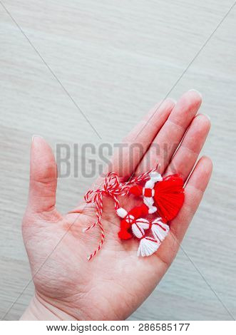 Bulgarian Traditional Spring Decor Martenitsa, Holding In Hand, Wooden Background. Baba Marta Holida