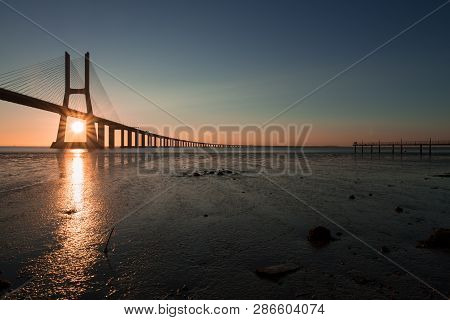 Peaceful Atmosphere At Vasco Da Gama Bridge In Lisbon During Sunrise. Ponte Vasco De Gama, Lisboa, P