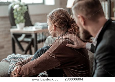Curly Dark-haired Teenage Girl Sitting With Her Back To Father