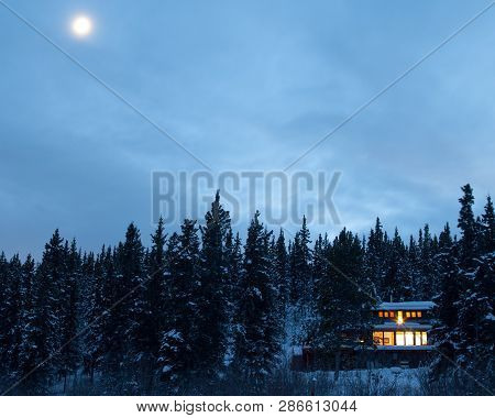 Warm Lights Of Cozy House In Forest Yukon Canada