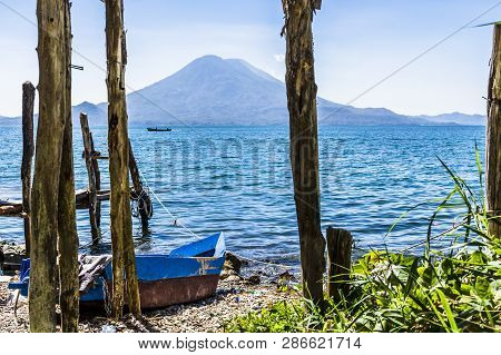 Traditional Boat On Beach At Lake Atitlan With Atitlan & Toliman Volcanoes On Horizon, Guatemala, Ce