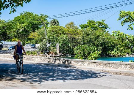 Negril , Jamaica - February 17 2019: Coastal Street And Sunny Day On The Caribbean Island. Cars Driv