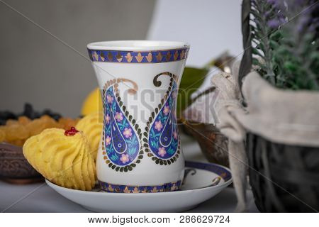 Armudu White Glass  With Blue Print In The Form Of A Buta On A White Saucer With A Blue Frame And Bi