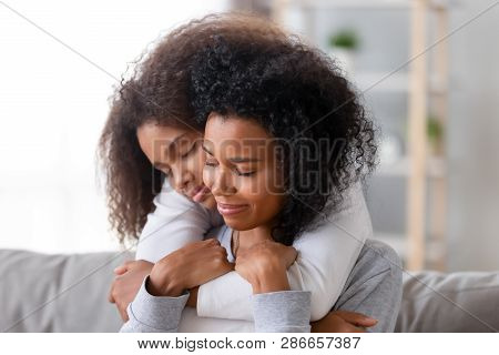 Loving Mother And Daughter With Closed Eyes Embracing