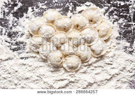 Raw Dumplings, Flouted Lie In The Shape Of A Heart On Wooden Board