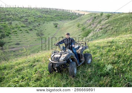 The Boy Is Traveling On An Atv.