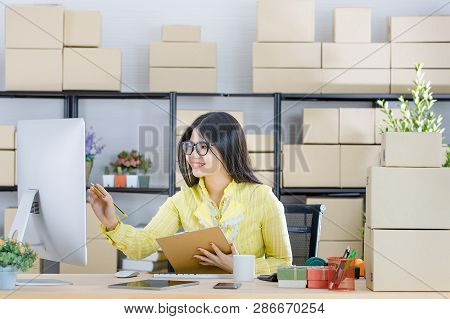 Young Attractive Asian Businesswoman, Long Black Hair, Wearing Glasses, Yellow Blouse, Recheck Order