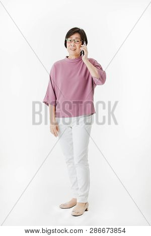 Full Length Portrait Of Aged ,senior Asian Woman, Short Hair, Wearing Glasses, In Casual Fashion, Sm