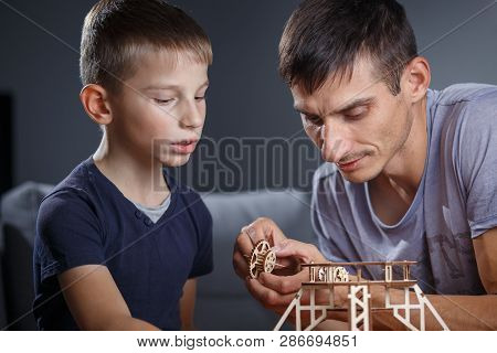 Young Boy Assembling Constructor With His Father