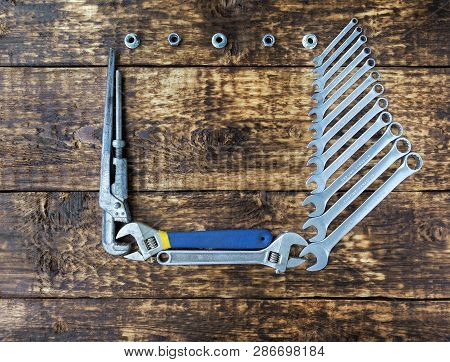 A Set Of Combined Keys And Old Adjustable Keys On An Old Wooden Background With A Place For Copy Spa