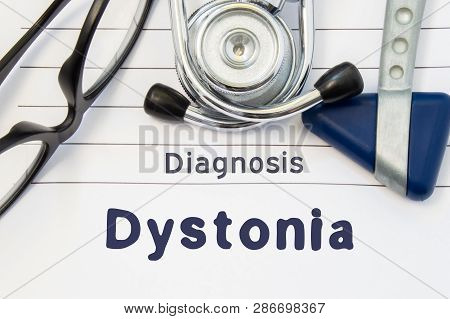 Neurological Diagnosis Of Dystonia. Neurological Hammer, Stethoscope And Doctors Glasses Lie On Doct