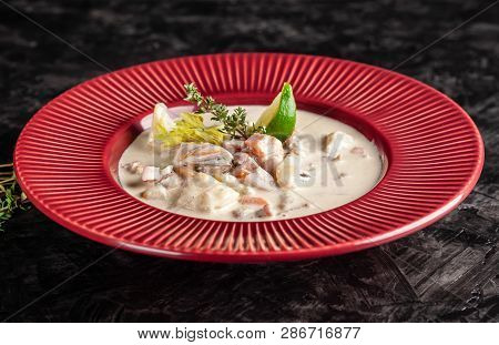 The Concept Of American Cuisine. Clam Chowder Potato Soup With Sea Food, Mussels, Salmon. Fish Broth