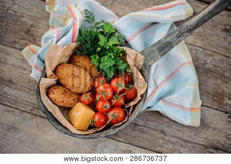 View From Above On The Georgian Dish Mchadi In The Pot On A Light Striped Tablecloth