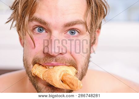 Handsome Young Man Enjoying His Morning Cup Of Coffee Laying In Bed Hotel Room Happy Smiling. Handso