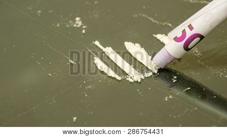 Curled 500 Euro Bill Vaccuums The White Powder. Four Lines Of White Powder On The Table A Curled 500